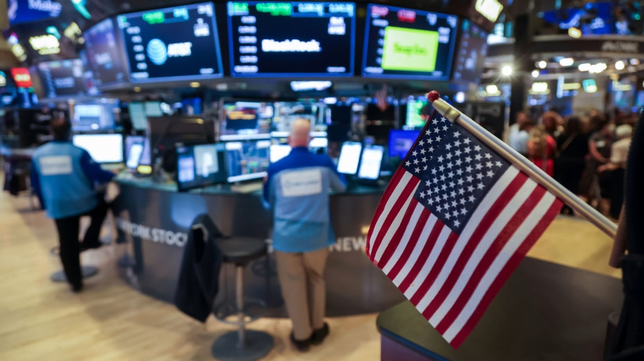 The floor of the New York Stock Exchange with American flags.