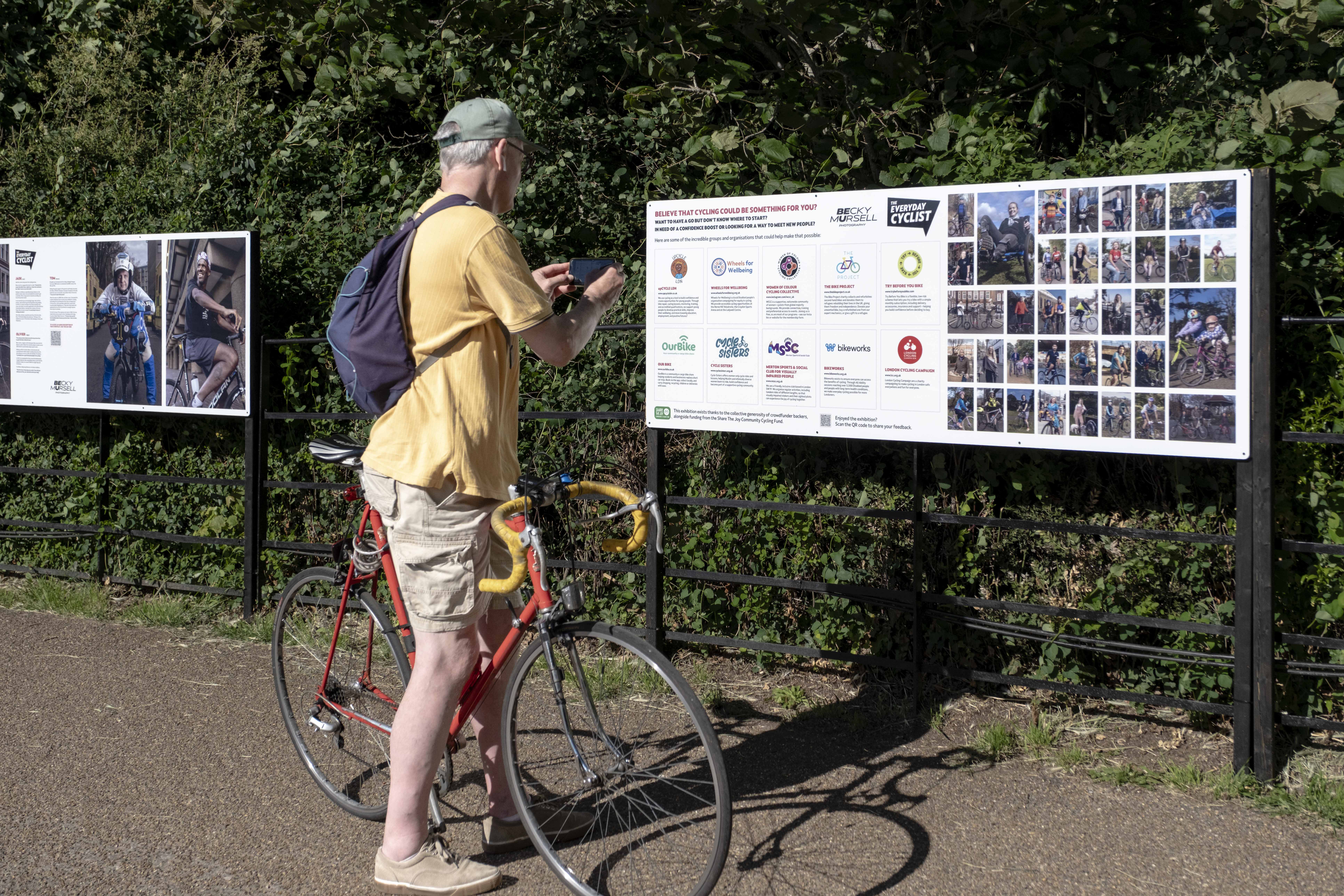 cyclist stops to look at The Everyday Cyclist exhibition by Becky Mursell, Osterley Park 2026