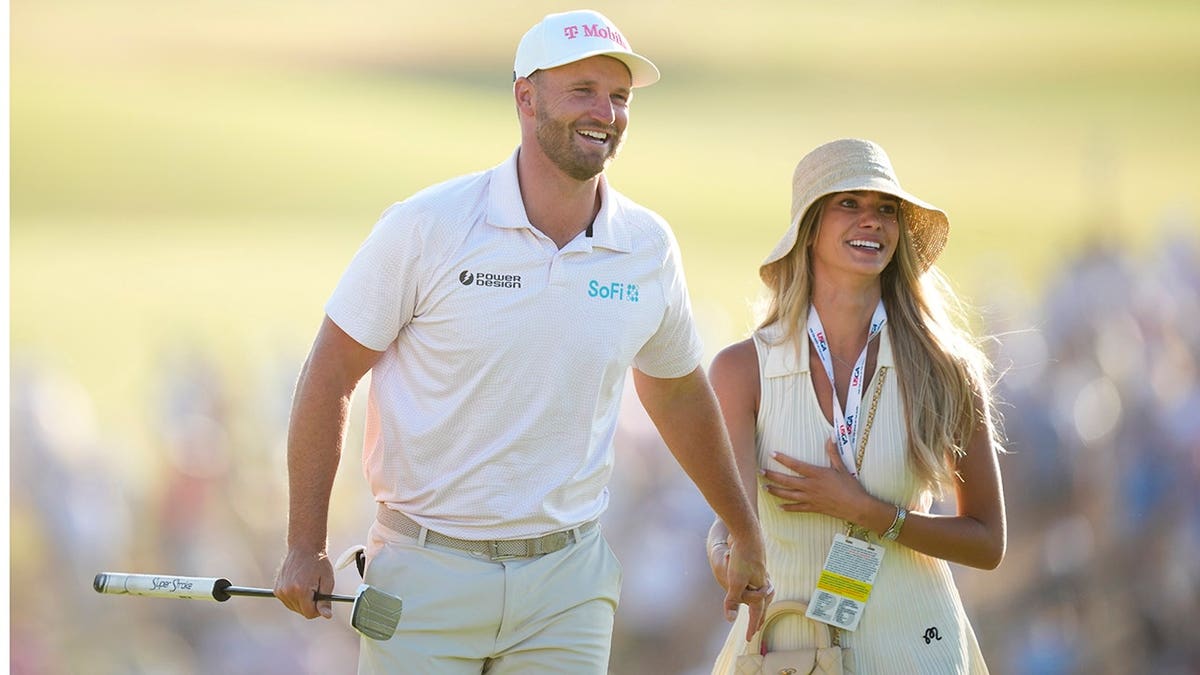 Wyndham Clark standing with his girlfriend Emily Tanner at Shinnecock Hills Golf Club