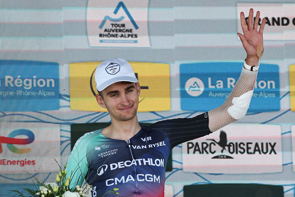 Decathlon CMA CGM Team's French rider Paul Seixas celebrates on the podium with the most combative rider award after the 7th stage of the Tour Auvergne-Rhone-Alpes cycling race (formerly known as the Criterium du Dauphine), 133,6km between La Bridoire and Grand Colombier in the French Alps on June 13, 2026. (Photo by Anne-Christine POUJOULAT / AFP)