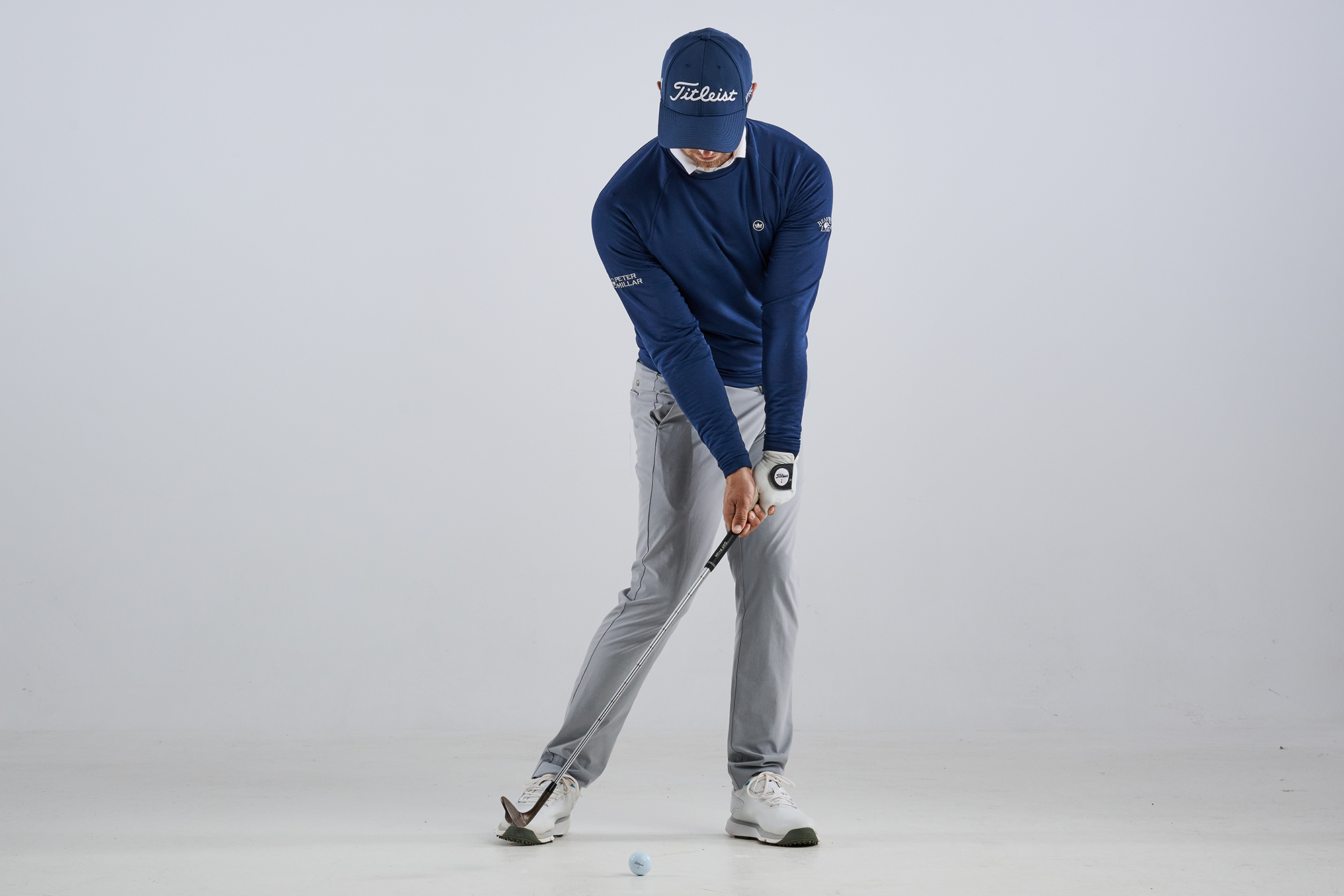 Alex Buckner demonstrating the impact position for a lower ball flight with a wedge, with hands forward and plenty of shaft lean
