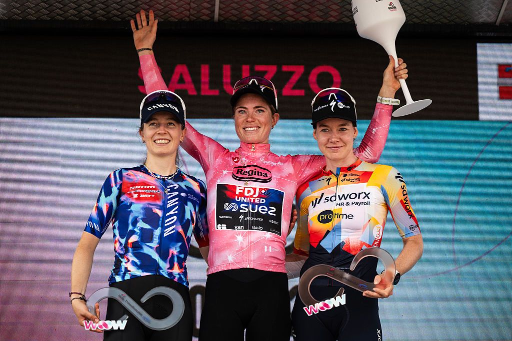 FDJ SUEZ Dutch rider Demi Vollering (C) wearing the overall leader's pink jersey and winner of the Giro d'Italia Women 2026 - Tour of Italy cycling race poses on podium with second placed Canyon SRAM German rider Antonia Niedermaier (L) and third placed SD Worx Dutch rider Anna Van Der Breggen after the 9th stage of the Giro d'Italia Women 2026 - Tour of Italy Women cycling race between Saluzzo and Saluzzo, Italy, on June 7, 2026. (Photo by MARCO BERTORELLO / AFP)