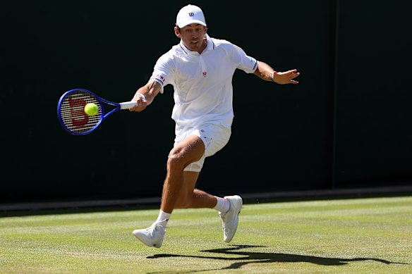 Alex De Minaur stretches for a forehand.