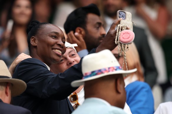 Venus Williams takes a selfie with a fan while watching sister Serena Williams in action on Tuesday.