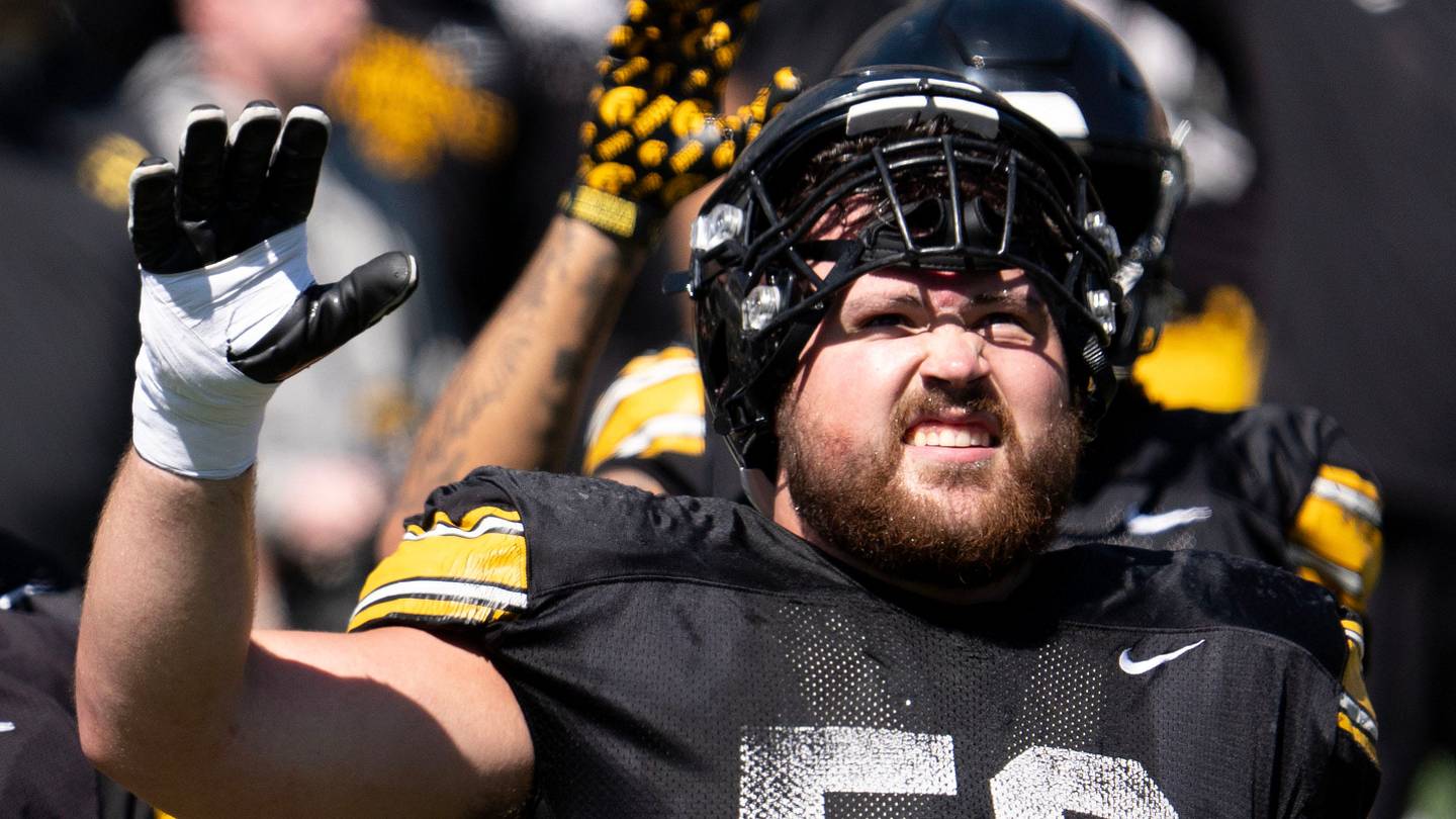 Iowa offensive linemen Leighton Jones (64), Cael Winter (61), and Trevor Lauck (59) wave to patients of the Stead Family Children’s Hospital April 25, 2026 during the team’s spring practice at Kinnick Stadium in Iowa City, Iowa.