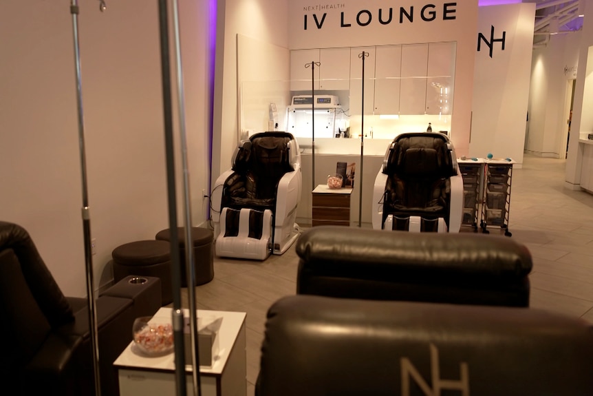 A clinic with armchairs next to IV drips.