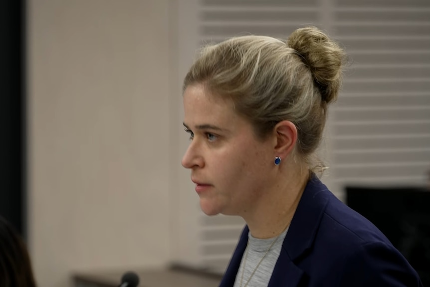Woman standing in a room speaking