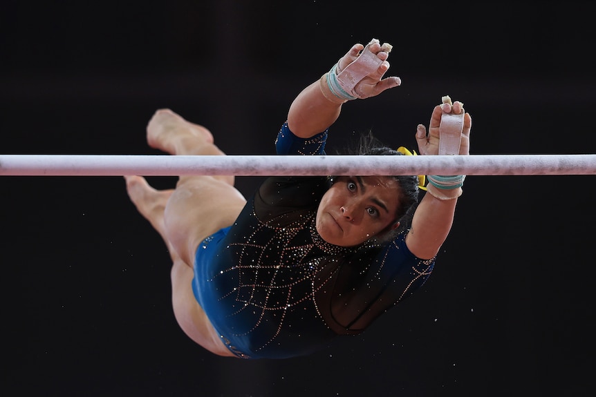 Australian gymnast Georgia Godwin reaches for the bar while performing her routine in the Commonwealth Games team final.