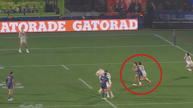 Taine Tuaupiki is knocked over by Valentine Holmes.