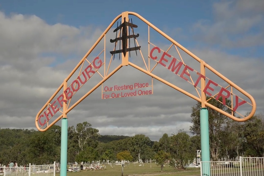 a boomerang that says cherbourg cemetery, resting place for our loved ones
