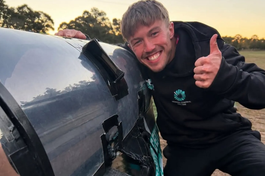 Nathan Fitzgerald smiles at the camera with a big thumbs-up