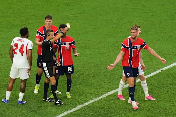 Ajer is shown a yellow card for his protests. 
