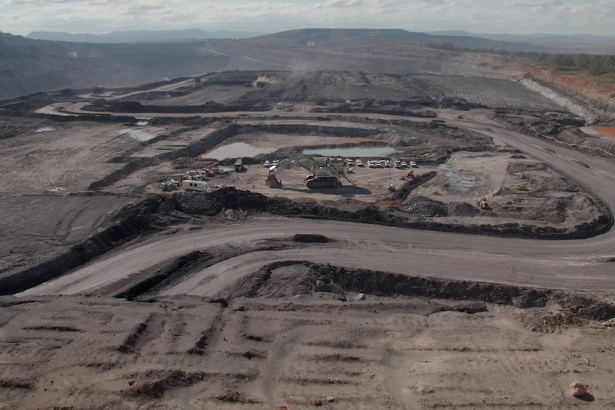 a drone shot over an open cut coal mine pit