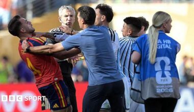 Argentina's head coach Lionel Scaloni tries to intervene as Argentina's Leandro Paredes clashes with Spain defender Eric Garcia