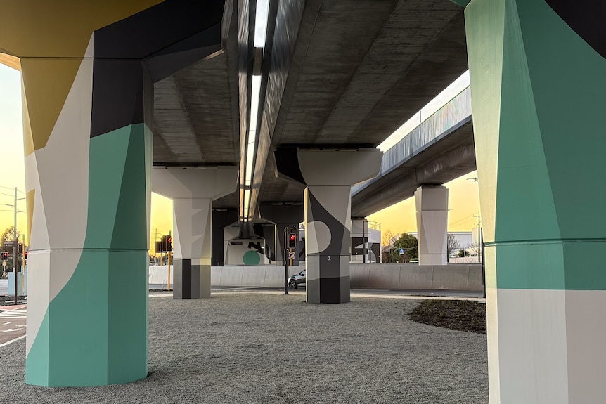 Shades of green from olive to teal on concrete piers.