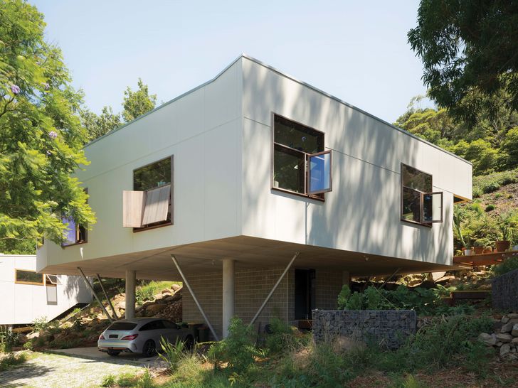 The house is elevated on four columns, which minimised excavation on the steep site.