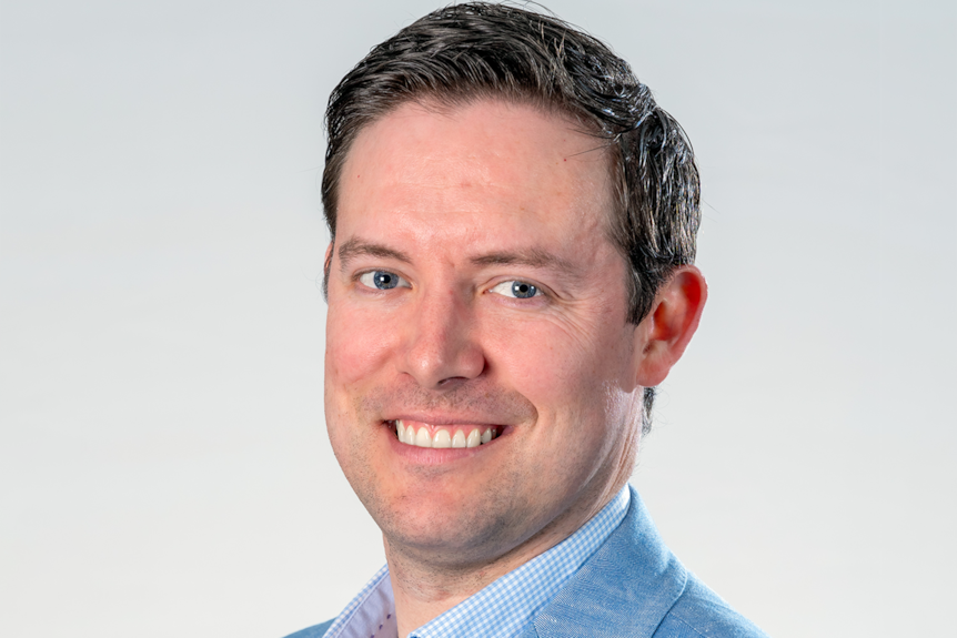 A close up photo of a smiling man
