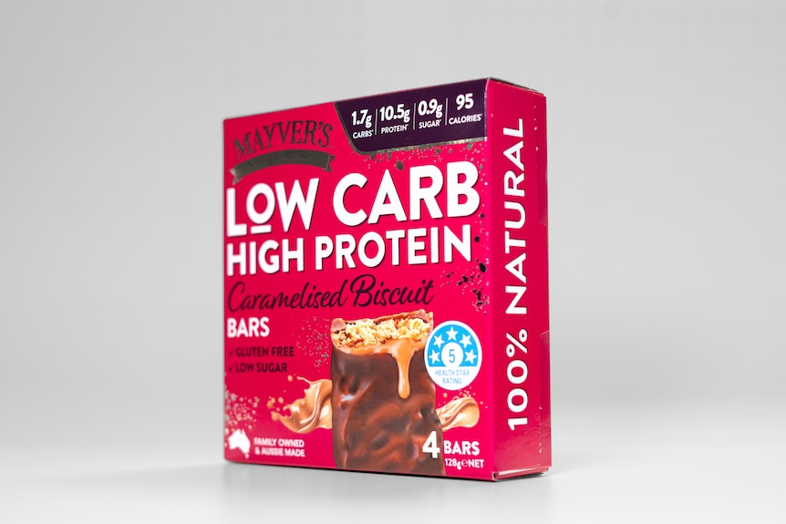 A pink box of protein bars against a white background.