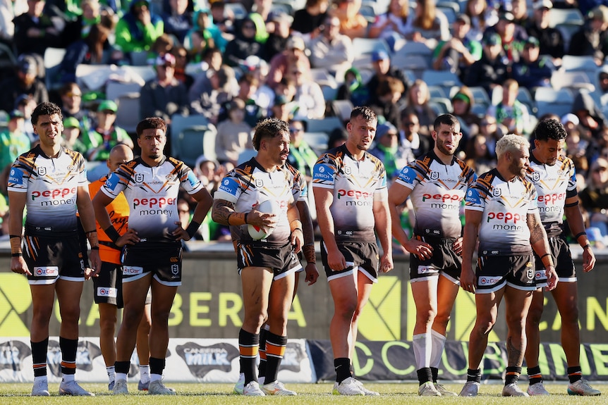 A group of NRL players look sad after conceding a try
