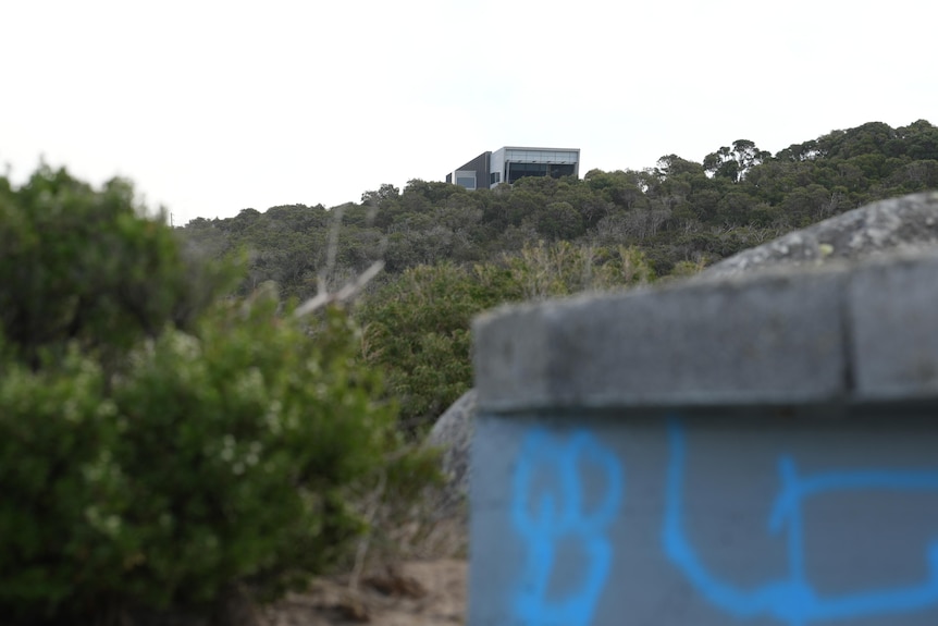 Graffiti on one of the outbuildings, with the National Anzac Centre visible on Mt Clarence in the background.