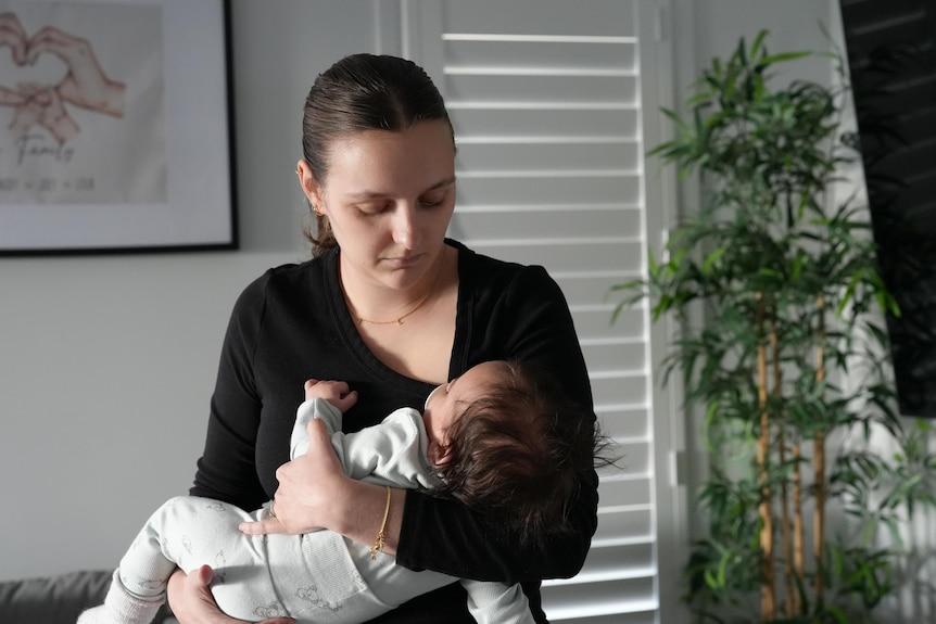 a woman holds a baby