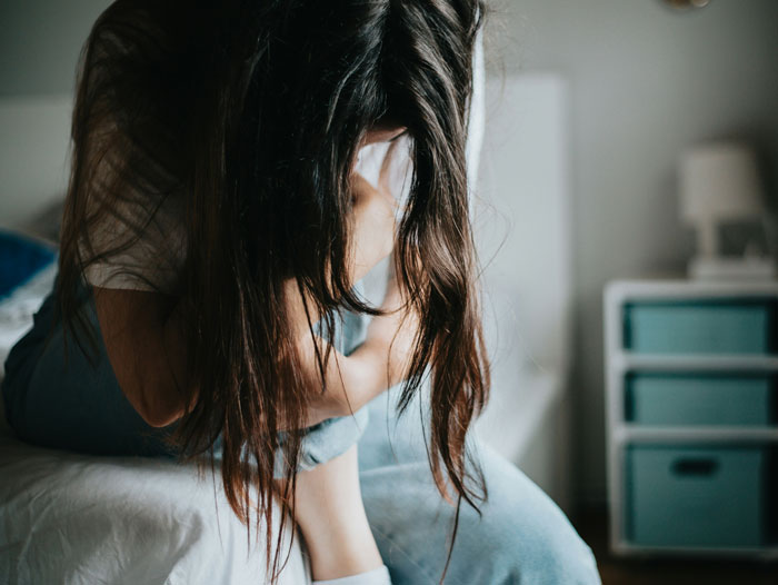 A woman with her head in her hands, showing patients who tried to outsmart their doctors and failed.