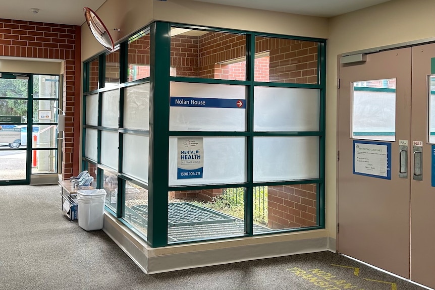A sign in a corridor points to Nolan House
