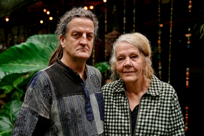 AN older couple looking stern