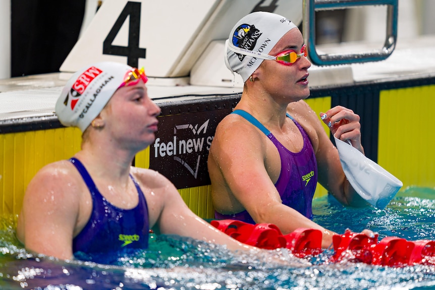 Kaylee McKeown and Mollie O'Callaghan in the water at the end of a race.