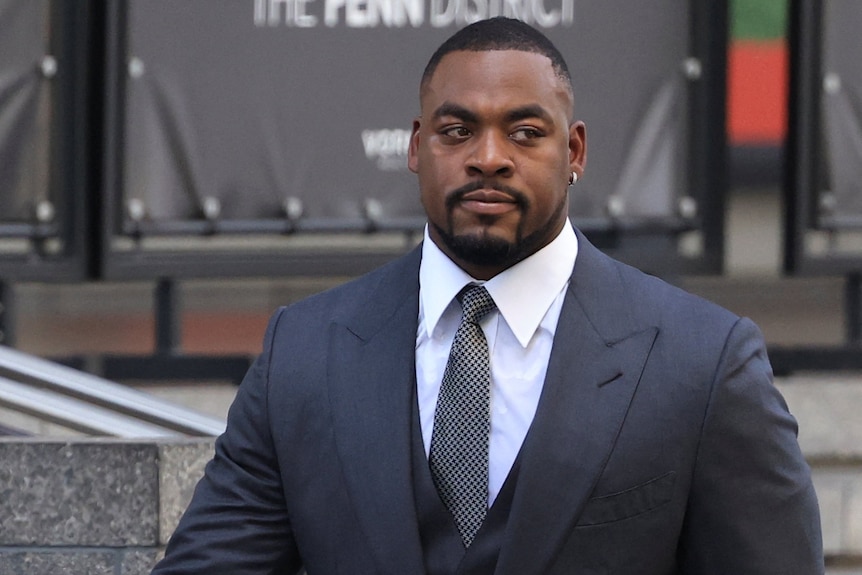 A man in a black suit.