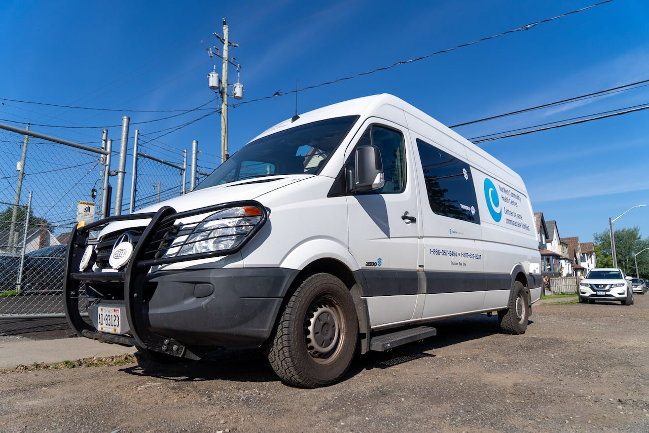A white van is seen on a road.