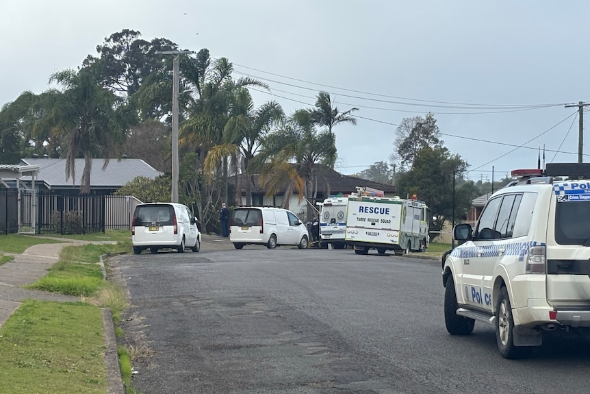 Police vehicles on a suburban street.
