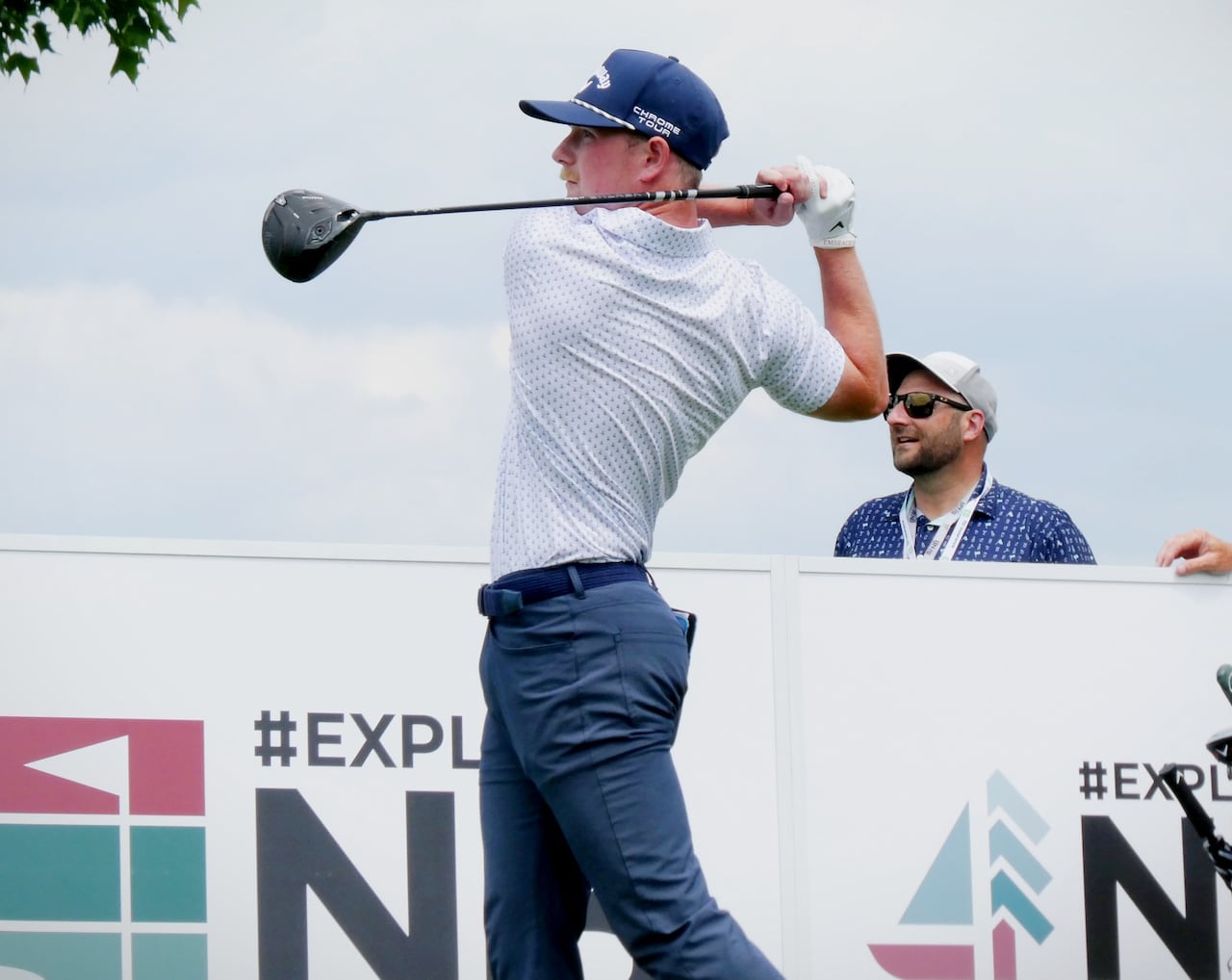 The moment right after a man swings a driver golf club.