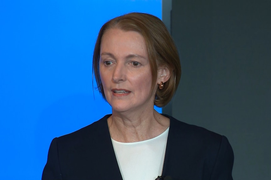 Vicky Brady speaks for the first time since Telstra outage. She has short brown hair and brown eyes. Wears a navy suit.