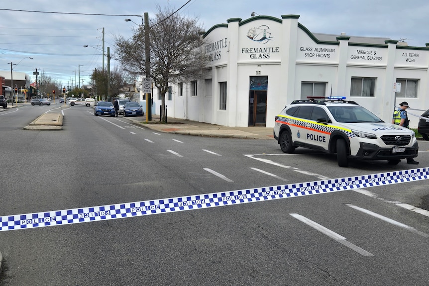 Police tape across a street outside Fremantle Glass