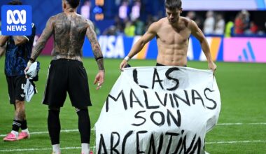 Argentina players hold up 'Falklands are Argentine' banner after World Cup victory over England