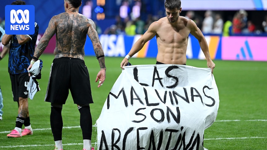 Argentina players hold up 'Falklands are Argentine' banner after World Cup victory over England