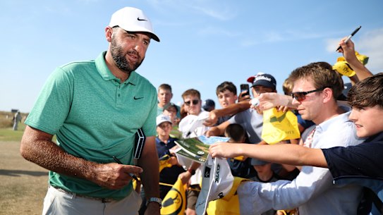 Scottie Scheffler of the United States signs autographs for fans ahead of the Open Championship at Royal Birkdale.
