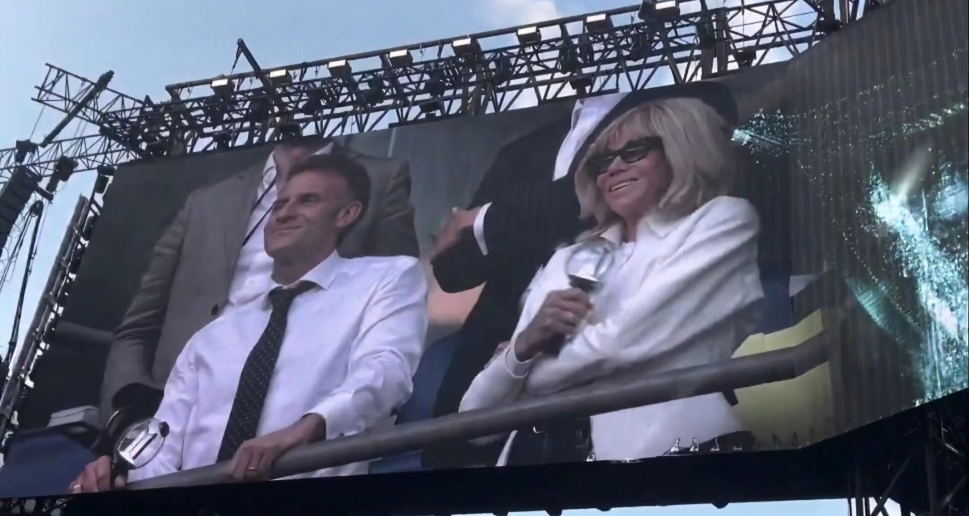 French President Emmanuel Macron and first lady Brigitte Macron are featured on the giant screen during a BTS concert at the Stade de France in Paris, Friday (local time). Captured from X (formerly Twitter)