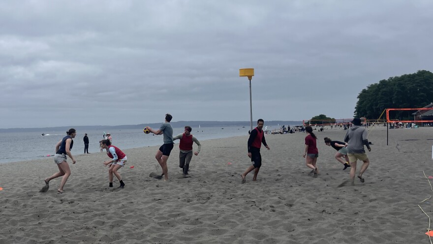 People playing korfball on a beach.