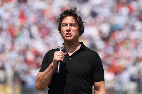 Tom Cruise addresses the crowd before the game.