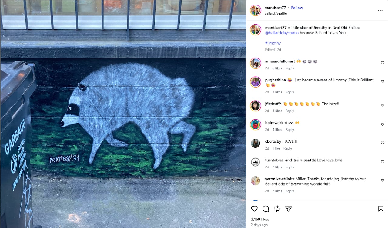 A mural of a drawing of a very round racoon on a building wall