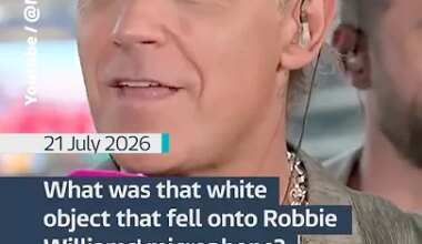 What was that white object that fell onto Robbie Williams' microphone? - YouTube