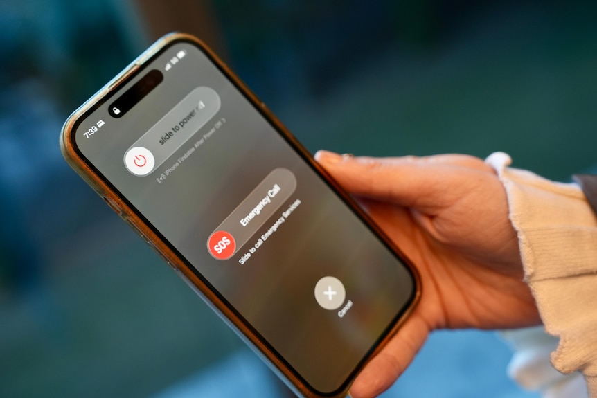 Close up of mobile phone with SOS message due to Telstra outage