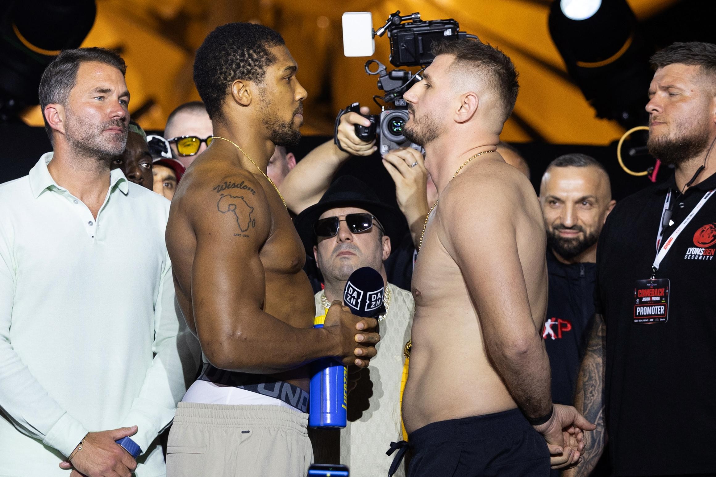 Britain’s boxer Anthony Joshua (L) faces off with Albania’s boxer Kristian Prenga during the weigh-in ceremony on the eve of their heavyweight bout in Jeddah on July 24, 2026. Briton Anthony Joshua, a two-time heavyweight champion, will face Kristian Prenga at “The Comeback” event in Saudi Arabia on July 25. (Photo by AFP via Getty Images)
