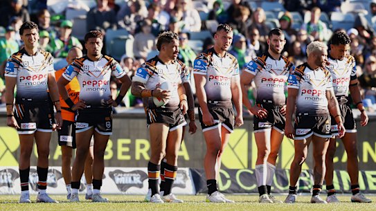 Tigers players wait for a try conversion