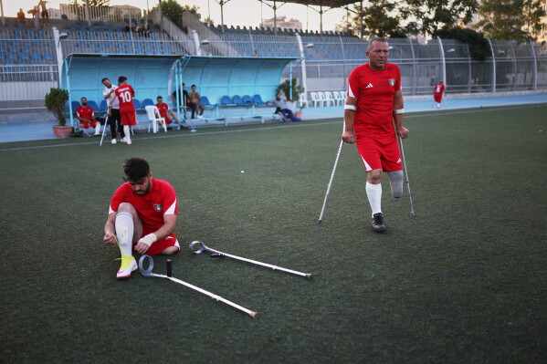 Players from Omayya Club prepare before the final of Syria's first football tournament for people with disabilities at Al-Muhafaza Stadium in Damascus, Syria, Wednesday, July 29, 2026. (AP Photo/Ghaith Alsayed)