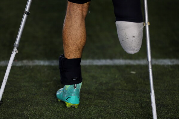 The prosthetic leg and crutches of a player are seen during the final of Syria's first football tournament for people with disabilities at Al-Muhafaza Stadium in Damascus, Syria, Wednesday, July 29, 2026. (AP Photo/Ghaith Alsayed)