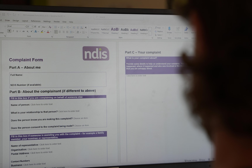 a photo of the NDIS complaints form and the back of a man's head
