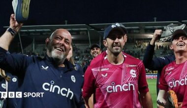 Darren Lehmann holds a trainer aloft during celebrations with his Northamptonshire Steelbacks players at the T20 Blast final